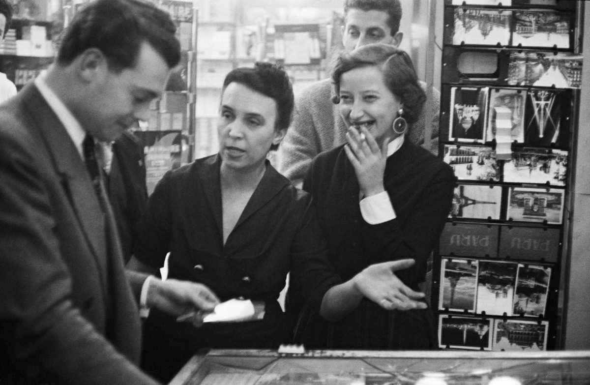 Checking out the Lotto ticket at a shop, Paris in the 1950s.