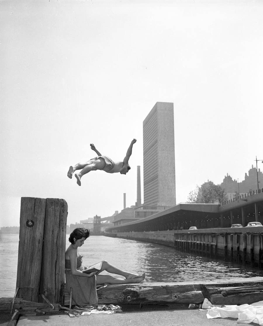 A man dives off a pier into the East River on May 21, 1955.