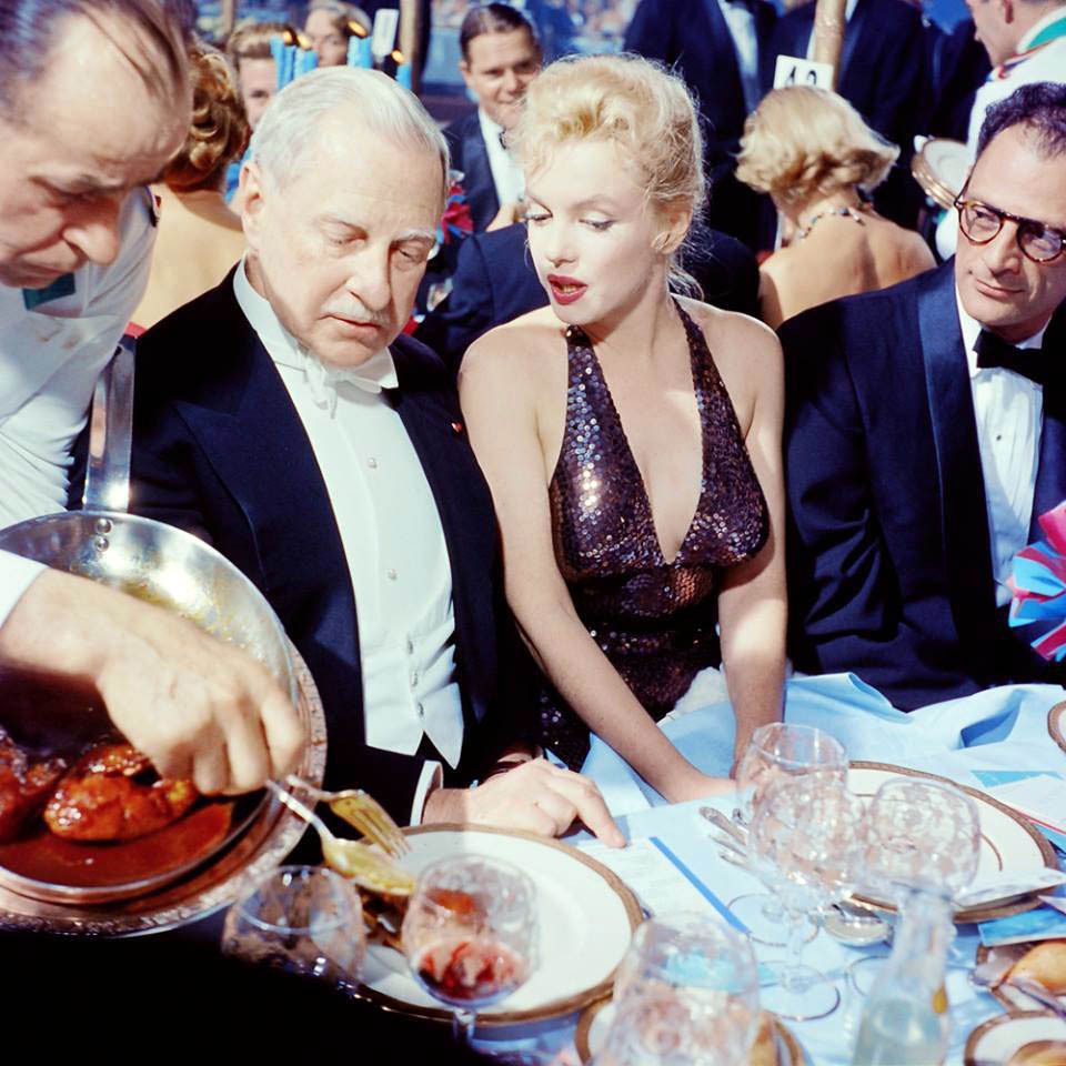 Winthrop Aldrich, Marilyn Monroe, and Arthur Miller attend the April in Paris Ball, Waldorf Astoria Hotel, 1957.