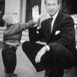 “Lloyd Bridges crouches in his driveway while his young son, Jeff, hands him a toothbrush outside their home in Los Angeles.” Photographed 1951 by Murray Garrett.