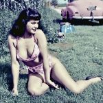 Bettie Page waiting by the side of the road