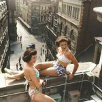 Two women in swimwear soak up the sun on a rooftop in Piccadilly, London. Photo by Bert Hardy,1953 c