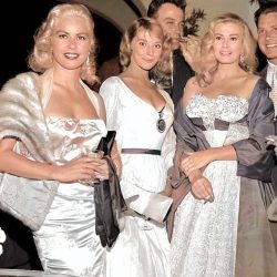 Vikki Dougan and Anita Ekberg photographed at a Hollywood party with Jeanne Carmen, 1957 ,