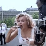 Marilyn Monroe eating a hot dog from a stand with Arthur Miller. Photos by Sam Shaw, 1957.